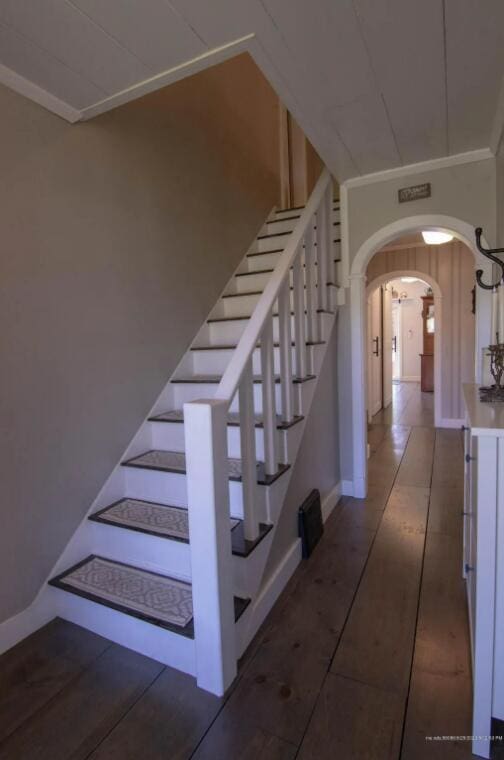 60 St John Rd, Fort Kent, ME 04743 - stairs with arched walkways, crown molding, baseboards, and tile patterned flooring