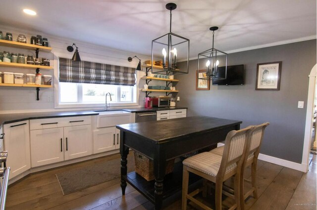 60 St John Rd, Fort Kent, ME 04743 - kitchen featuring a sink, open shelves, dark countertops, crown molding, and dark wood finished floors