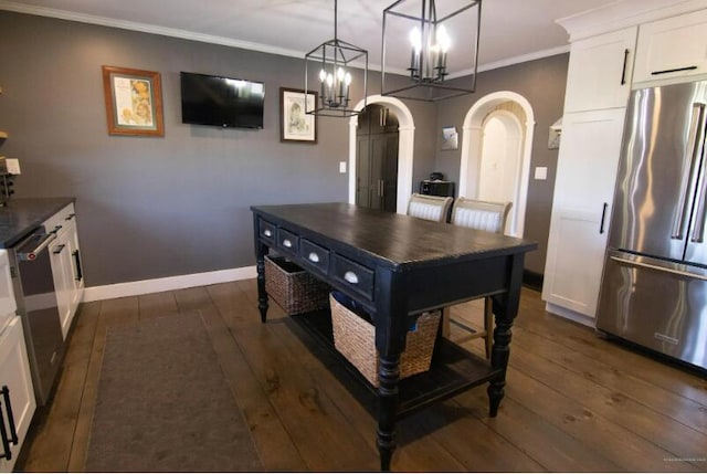 60 St John Rd, Fort Kent, ME 04743 - kitchen with freestanding refrigerator, arched walkways, dark wood-style flooring, white cabinetry, and baseboards