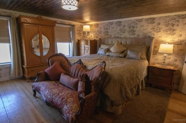 60 St John Rd, Fort Kent, ME 04743 - bedroom featuring wallpapered walls, multiple windows, light wood-style floors, and baseboards