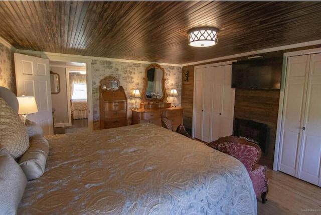 60 St John Rd, Fort Kent, ME 04743 - bedroom with wood finished floors, wood ceiling, and a fireplace