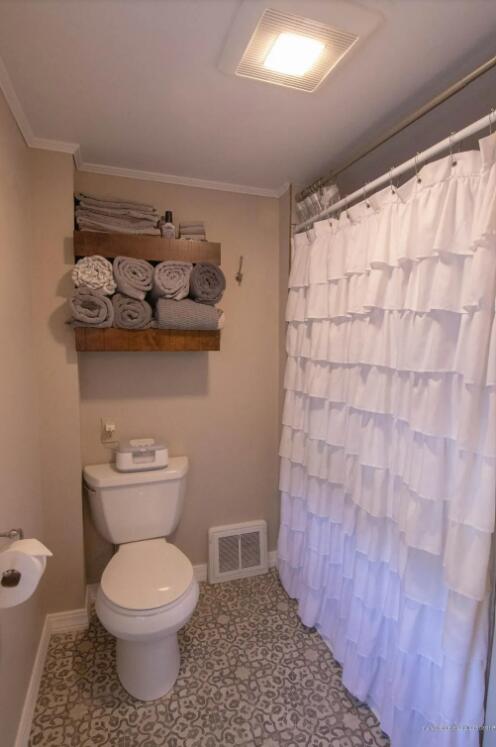 60 St John Rd, Fort Kent, ME 04743 - full bath with toilet, baseboards, crown molding, and a shower with shower curtain