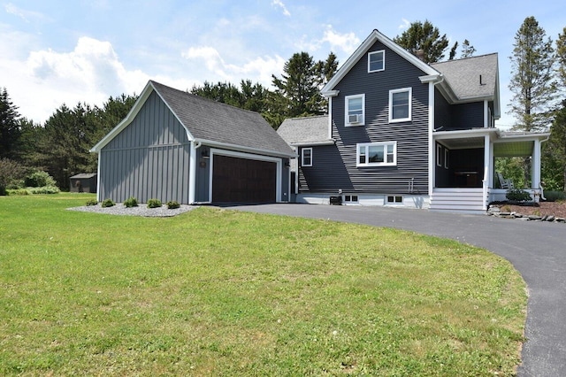 60 St John Rd, Fort Kent, ME 04743 - view of front of property featuring a front yard, an outbuilding, a garage, board and batten siding, and roof with shingles