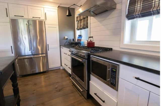 60 St John Rd, Fort Kent, ME 04743 - kitchen with appliances with stainless steel finishes, island range hood, dark countertops, white cabinets, and dark wood-style flooring