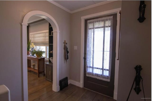 60 St John Rd, Fort Kent, ME 04743 - entryway with healthy amount of natural light, ornamental molding, dark wood-type flooring, arched walkways, and baseboards
