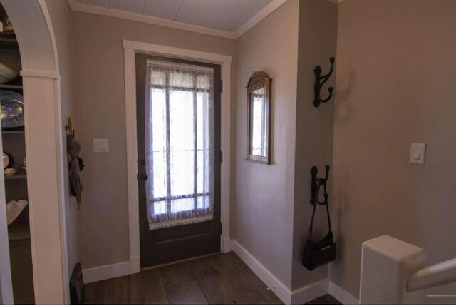 60 St John Rd, Fort Kent, ME 04743 - foyer with ornamental molding, baseboards, wood finished floors, and arched walkways