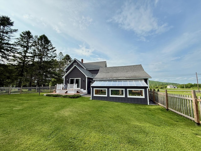 60 St John Rd, Fort Kent, ME 04743 - rear view of house with a deck, a chimney, board and batten siding, and roof with shingles