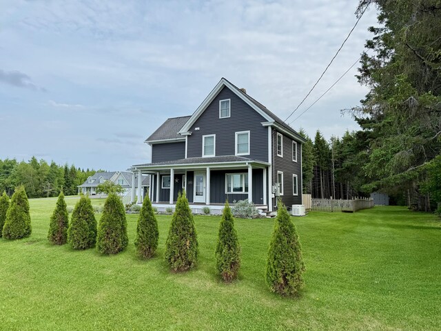 60 St John Rd, Fort Kent, ME 04743 - view of front of property with a porch, a front lawn, and central AC unit