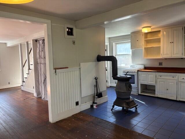 kitchen featuring dark wood-style flooring, open shelves, white cabinetry, and electric stove