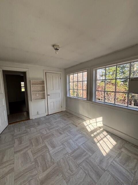 spare room featuring baseboards