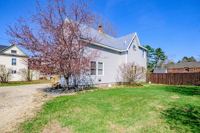 view of home's exterior featuring a chimney and dirt driveway