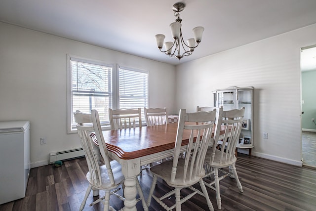 dining room featuring wood finished floors, a chandelier, baseboards, and a baseboard heating unit
