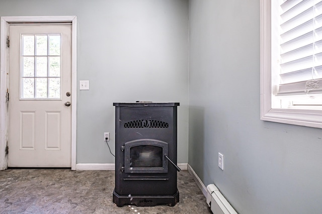 detailed view of a wood stove, baseboards, and baseboard heating