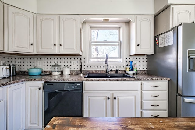 kitchen with a sink, dishwasher, dark countertops, stainless steel fridge with ice dispenser, and tasteful backsplash