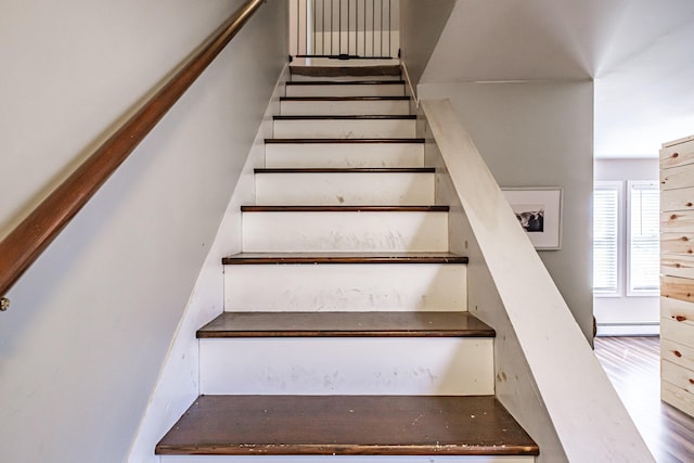 stairs with a baseboard heating unit