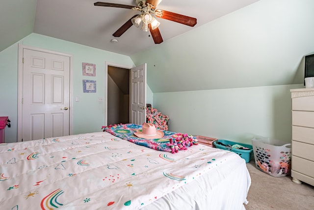 bedroom featuring vaulted ceiling, carpet flooring, and a ceiling fan