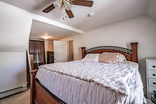 bedroom with baseboard heating, light colored carpet, a ceiling fan, and vaulted ceiling