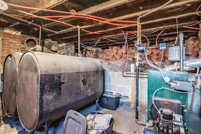 unfinished basement featuring oil tank and a heating unit