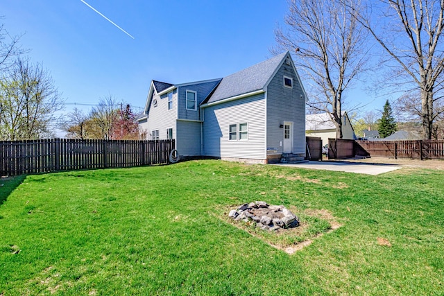 back of property featuring a patio area and an outdoor fire pit