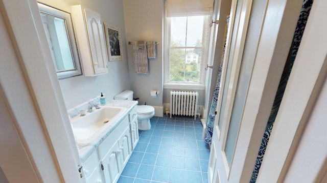 full bathroom with tile patterned floors, radiator heating unit, toilet, vanity, and curtained shower
