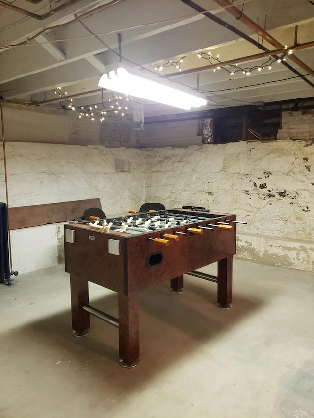 game room with unfinished concrete floors
