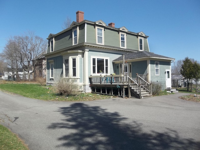 view of front of property with a chimney and a porch