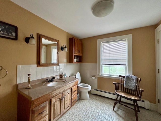 bathroom featuring vanity, toilet, and a baseboard heating unit