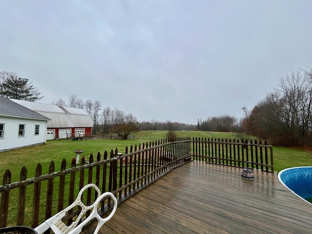 wooden deck with an outbuilding, a yard, and fence