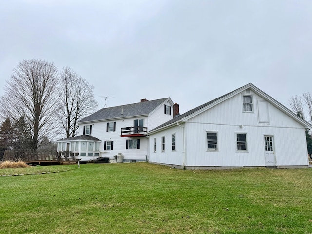 back of house featuring a yard and a wooden deck