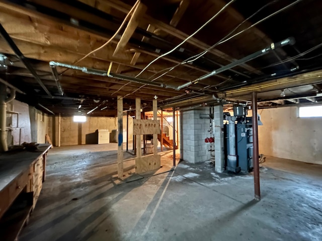 below grade area featuring stairs and a heating unit
