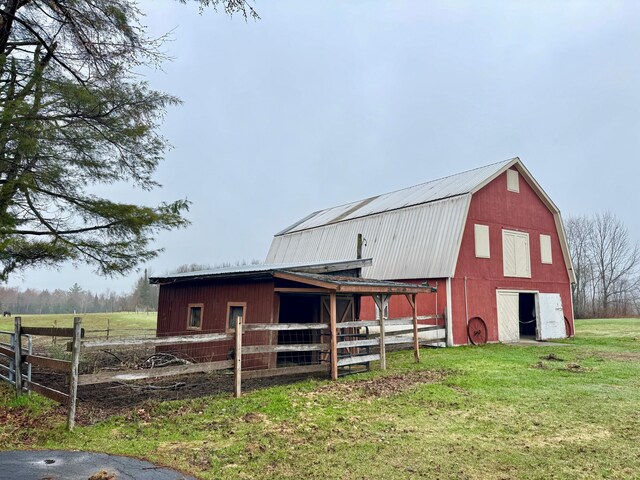 view of barn with fence