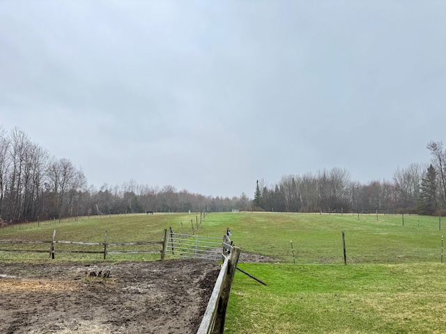 view of yard featuring fence and a rural view