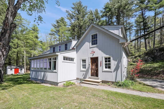 566 River Rd, Dresden, ME 04342 - view of front of home featuring entry steps, a front yard, and an outbuilding