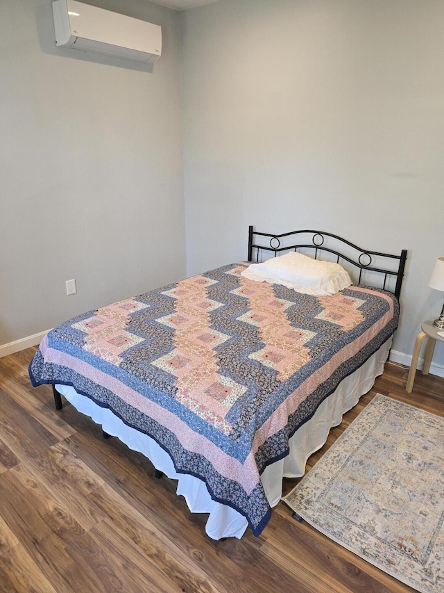 10 Middle St, Lisbon, ME 04252 - bedroom with baseboards, a wall mounted air conditioner, and wood finished floors