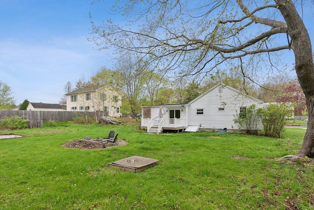 61 Westmore Ave, Biddeford, ME 04005 - rear view of property with an outdoor fire pit and a wooden deck