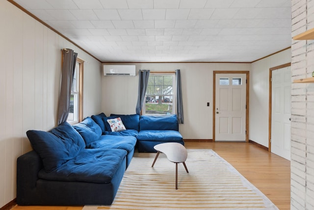 61 Westmore Ave, Biddeford, ME 04005 - living room with an AC wall unit, wood finished floors, crown molding, and baseboards