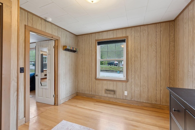 61 Westmore Ave, Biddeford, ME 04005 - unfurnished room featuring light wood finished floors, wooden walls, and a smoke detector