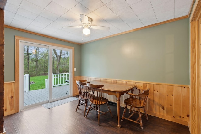 61 Westmore Ave, Biddeford, ME 04005 - dining room featuring wainscoting, hardwood / wood-style flooring, wooden walls, crown molding, and a ceiling fan