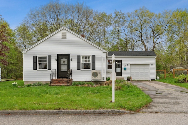 61 Westmore Ave, Biddeford, ME 04005 - view of front of property with ac unit, a garage, asphalt driveway, and a front lawn