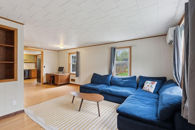 61 Westmore Ave, Biddeford, ME 04005 - living area featuring light wood-style flooring, a wall unit AC, and baseboards