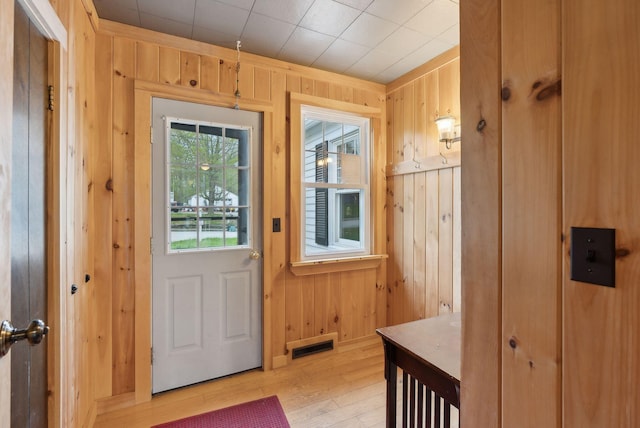 61 Westmore Ave, Biddeford, ME 04005 - doorway with wood walls and light wood-type flooring