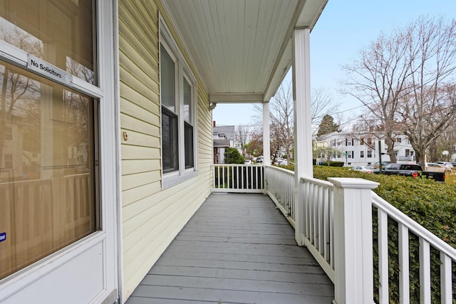 wooden deck featuring a porch and a residential view
