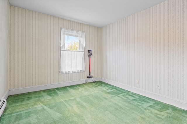 carpeted empty room with a baseboard heating unit