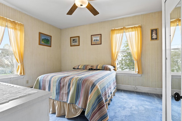 bedroom with carpet, a ceiling fan, and wallpapered walls