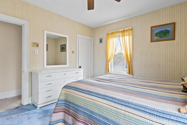 carpeted bedroom featuring baseboards, wallpapered walls, and a ceiling fan