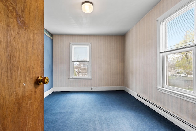 unfurnished room with wallpapered walls, baseboards, baseboard heating, and dark carpet