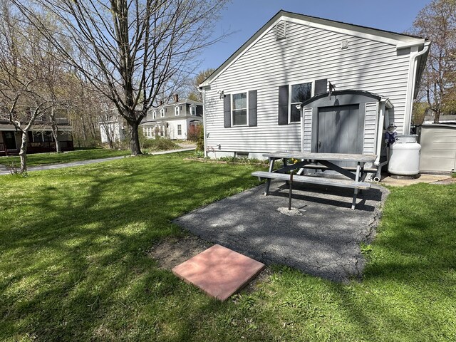 rear view of house with a yard