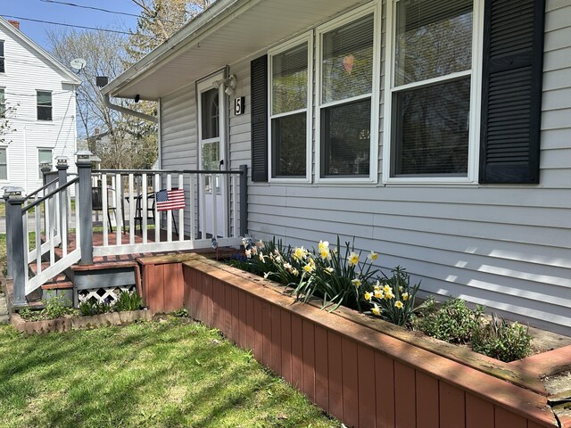 exterior space featuring covered porch and a yard