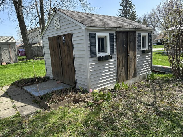 view of shed with fence