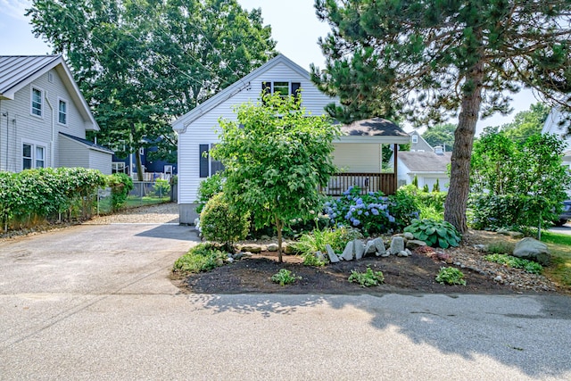 view of front facade with concrete driveway and fence